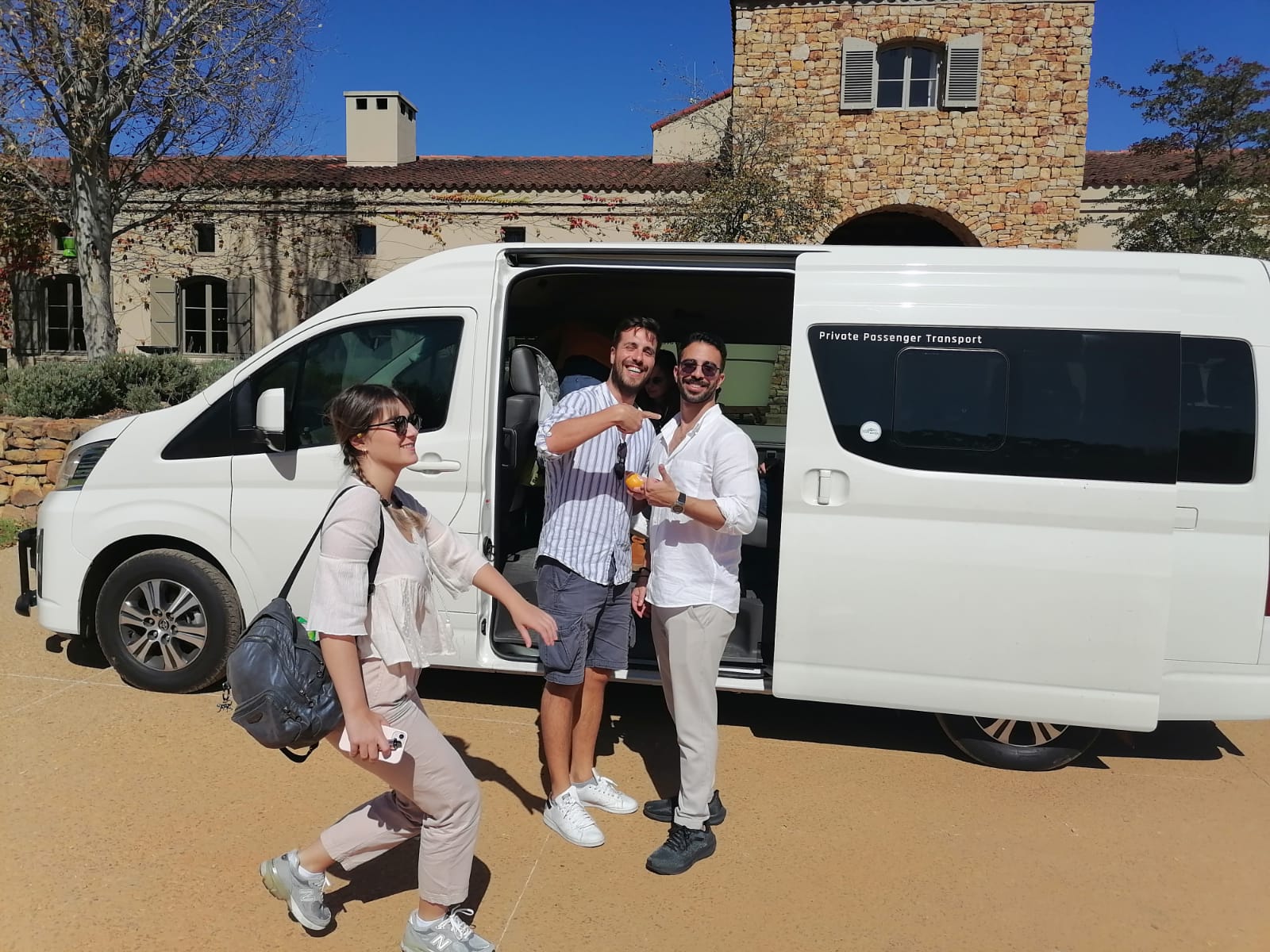 Guests stepping off a Stellenbosch Shuttles Toyota Quantum at a Cape winelands wine estate